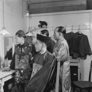 Actors in the dressing room before a play, featured in an event held to celebrate Japanese capitulation, 1945.